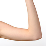Bare shoulder and arm bent at the elbow of one woman against a white background